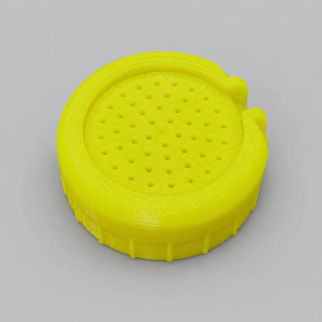 Tapa amarilla perforada fabricada mediante impresión 3D